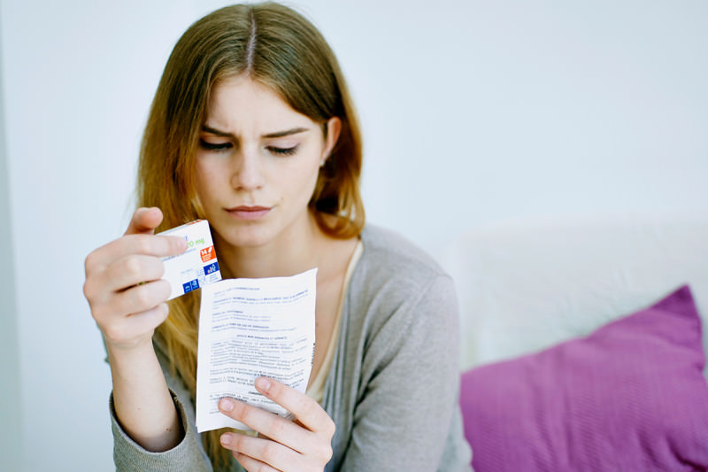 A woman reading a medical advice leaflet