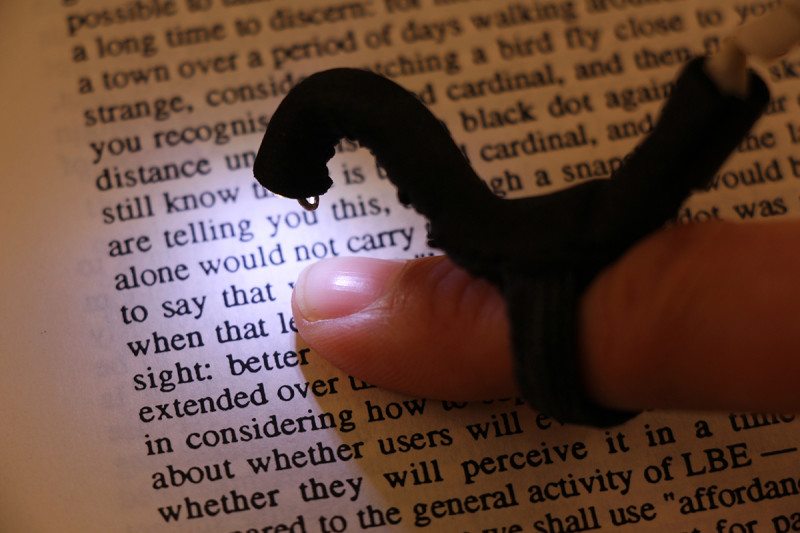 A close-up of the device being used to read a book