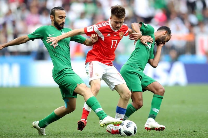 Players tustle for the ball during World Cup 2018's opening match between Saudi Arabia and Russia
